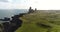 Iceland tourist walking in landscape showing Londrangar Cliffs on Snaefellsness