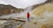 Iceland tourist walking in nature with volcano geothermal volcanic activity