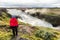 Iceland travel Gullfoss waterfall tourist woman looking over icelandic falls, famous attraction on the Golden circle