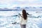 Iceland travel tourist enjoying view of nature landscape Jokulsarlon glacial lagoon on Iceland. Woman standing outdoors