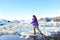 Iceland travel tourist walking on ice looking at view of nature landscape Jokulsarlon glacial lagoon on Iceland. Woman