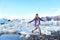 Iceland travel tourist walking on ice looking at view of nature landscape Jokulsarlon glacial lagoon on Iceland. Woman