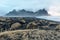 Iceland, Vestrahorn mount and black sand over the ocean.