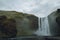 Iceland waterfall Skogafoss in Icelandic nature landscape. Famous tourist attractions and landmarks destination in Icelandic