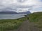 Iceland, West fjords, Hornstrandir, Latrar, June 26, 2018: Lonely man hiker with heavy backpack walking on footpath trail in