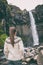 Iceland. Woman enjoying majestic Svartifoss waterfall. Female is visiting famous tourist attraction of Iceland