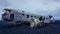 Iceland - Young man sitting on a crashed airplane