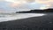 Icelandic Black Sand Beach Coast at Sunset, Volcanic Cliffside with Blue North Atlantic Ocean Water, Shot in 8K