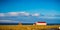 Icelandic farm house and shed with bright red roof and snow cap