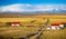 Icelandic farm houses and barns with bright red roofs and snow