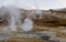 Icelandic geysir in summer, steam going out of ground