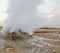 Icelandic geysir in summer, steam going out of ground