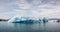 Icelandic glacial scenery, iceberg floating in the calm water, aerial shot