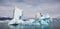 Icelandic glacial scenery, iceberg floating in the calm water, aerial shot