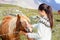 Icelandic horses - woman petting horse on Iceland