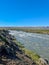 Icelandic landscape with flowing rivers surrounded by rocks and grass