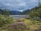 Icelandic landscape of Godland with Krossa river canyon, green sharp hills, blooming pink heather flower and