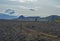 Icelandic lava desert landscape with two hikers couple on Laugavegur hiking trail with with view on Einhyrningur unicorn