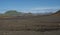 Icelandic lava desert landscapel with view on Tindfjallajokull glacier mountains and green hills. Fjallabak Nature