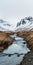 Icelandic River Amidst Snow Capped Mountains - Rustic Landscape