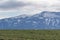 Icelandic sheep grazing in front of high mountains.