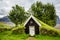 Icelandic traditional turf church covered with grass, trees and