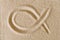Ichthys, Jesus Fish symbol, drawn in sand macro photo