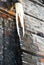 Icicle from drain pipe,wall with red bricks under ice, grunge background