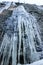 Icicle hangs from a rock in a winter nature.