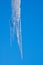 Icicle melting isolated against a blue sky