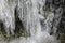 Icicles Formation on Side Of Mountain Rocks