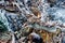 Icicles forming on ponderosa pine branches and rocks on the ground.