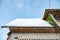 Icicles hang dangerously on the brick house roof