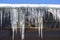 Icicles hanging on barn after cold winter night.