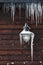 Icicles hanging from a lamp and drainpipe