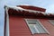 Icicles hanging from roof on wood house