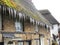 Icicles hanging from a thatched roof.