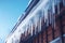 icicles on house roof in cold winter