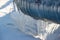 Icicles on the pipes of heating networks on the street on a winter day