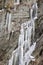 Icicles on a rocky mountain wall.