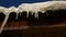 Icicles roof hanging off a roof in the dripping winter spring warming nature