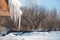 Icicles on the roof. Melt the snow on the roof of the house. Caution icicles. Ice hanging from the roof of the house