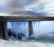 Icicles under wooden jetty in frozen lake