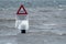 Icicles on a warning sign in a lake