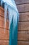 Icicles on a wooden structure in winter after snowstorm