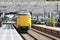 ICM Intercity train called Koploper rushes along platform at station Lansingerland Zoetermeer