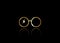 Icon of a golden round glasses, minimal style, isolated on black background