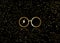 Icon of a golden round glasses, minimal style, isolated on black background