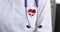 Icon with heart with cardiogram and stethoscope on white medical coat slow motion 4k movie