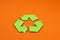 Icon of recycling made of green paper, the concept of protection, preservation of the environment